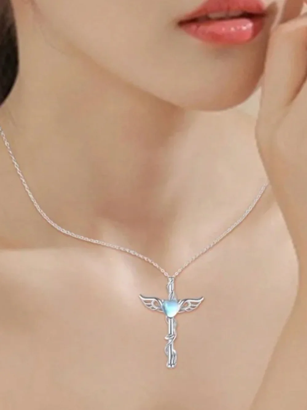 Silver Winged Cross Necklace with Blue Heart Gem